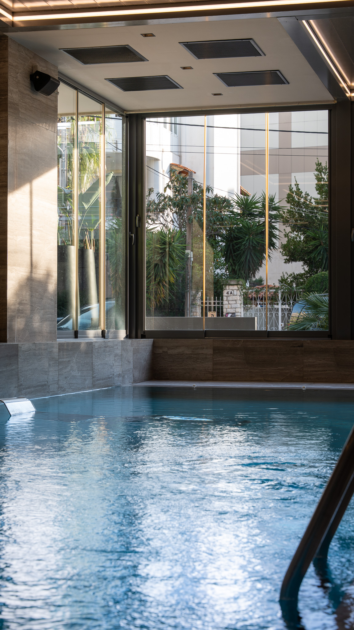 Dusit Suites Athens, vertical pool corner looking out to street greenery