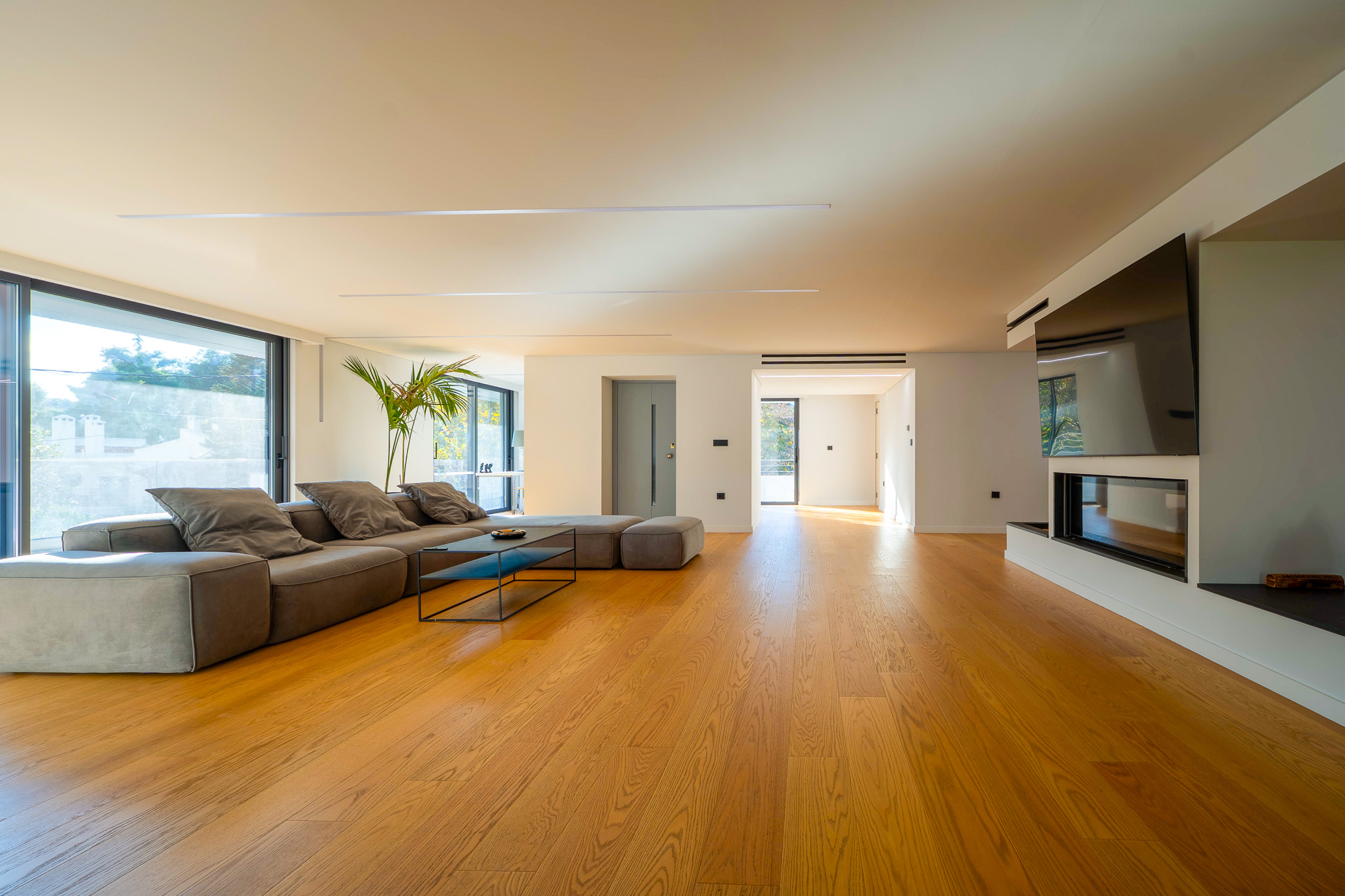 Villa Bond, wide living room with sectional and corridor