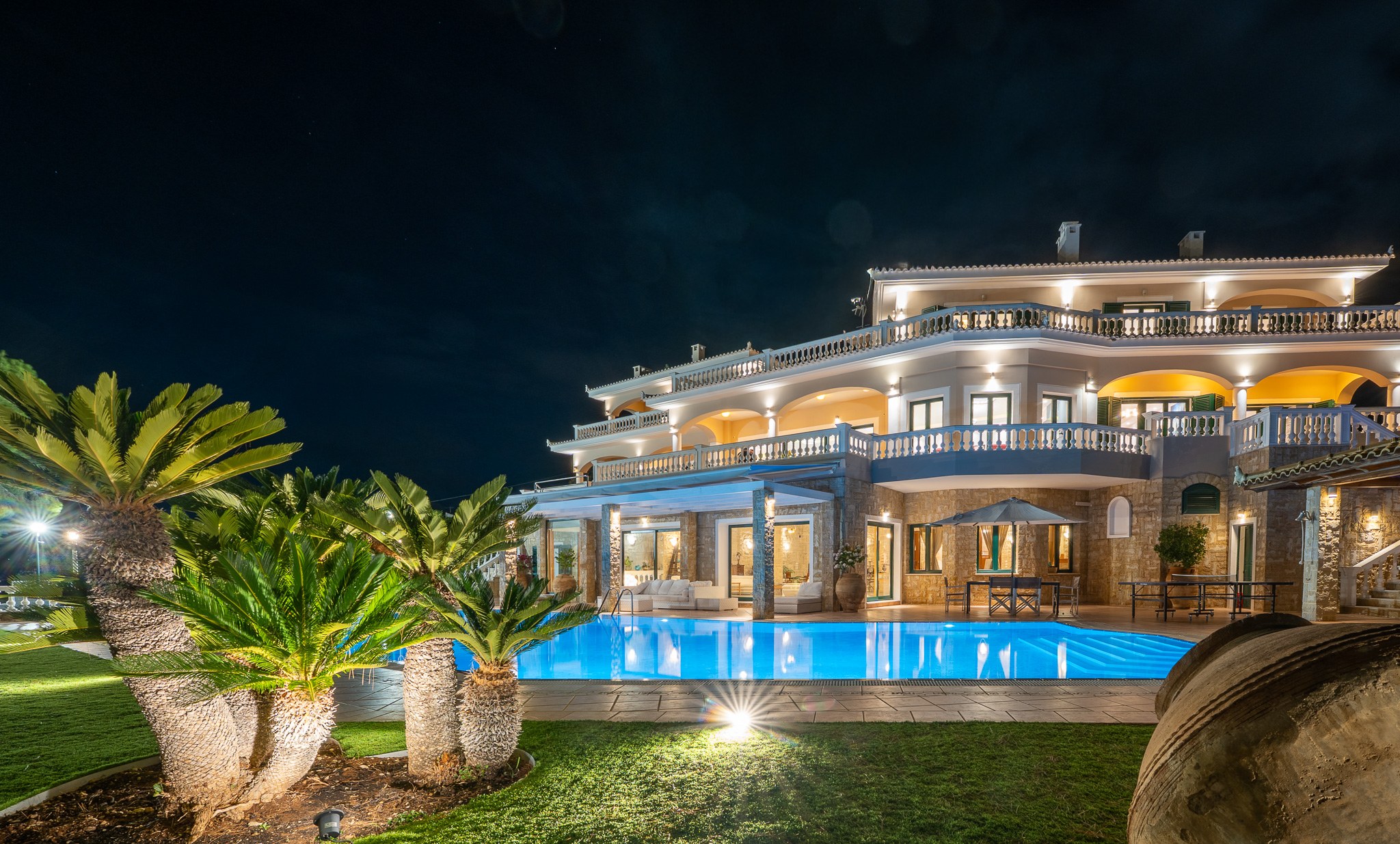Villa Rafaella, night exterior with palms and pool