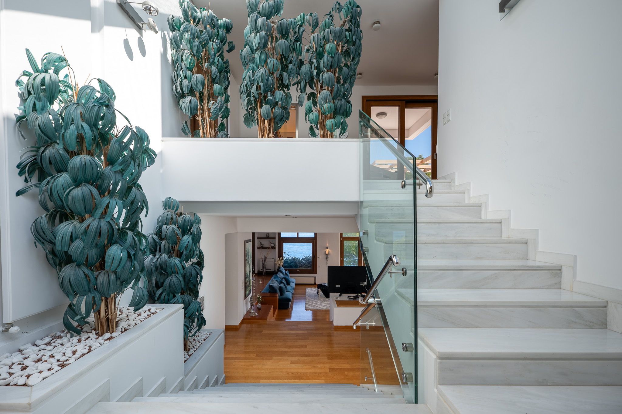 Villa Selene, marble entry stair with sculptural foliage