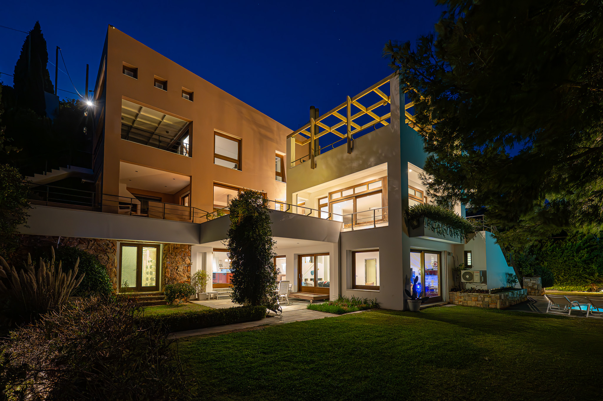 Villa Selene, twilight rear facade with lit terraces